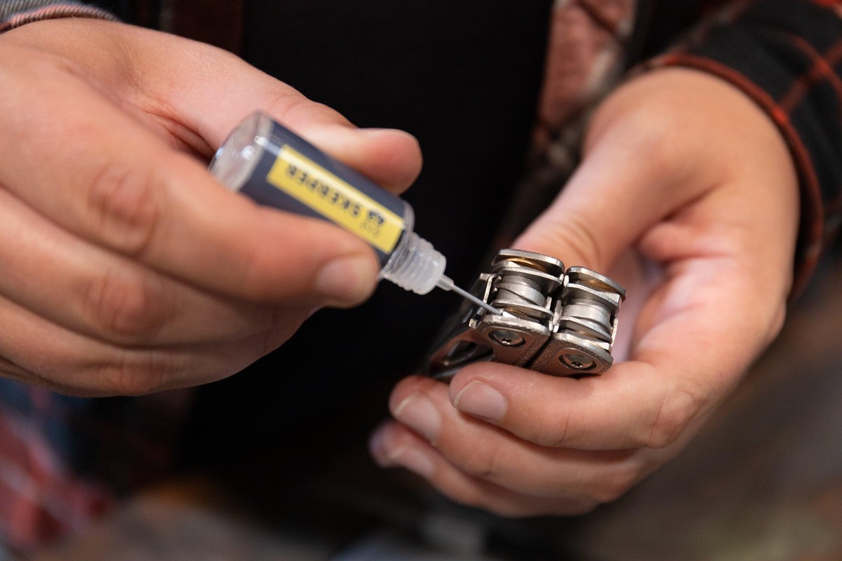 Multi-tool being cleaned and maintained with oil and cloth