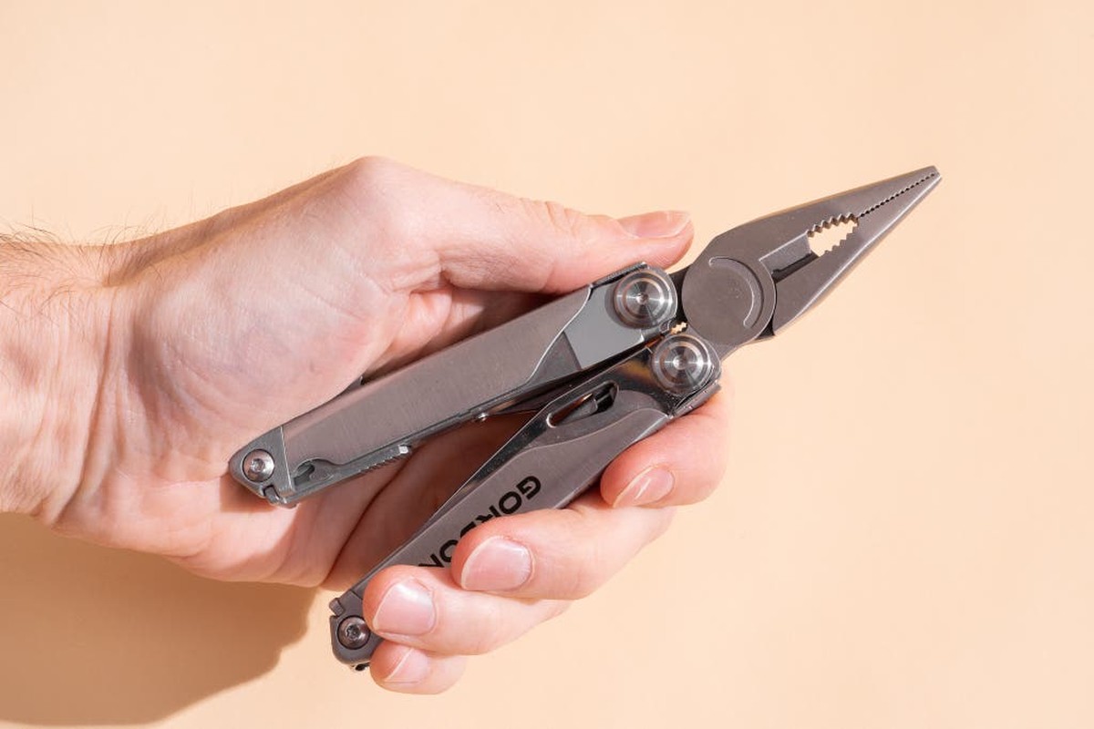 Hands safely using a multi-tool demonstrating proper technique